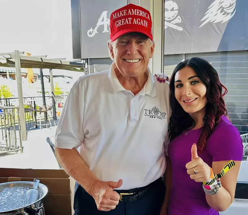 Image: donald trump and laura loomer flash the thumbs-up sign for a photo on November 5, 2023