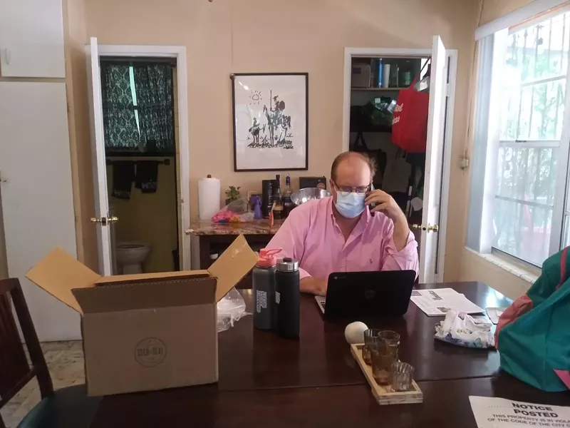 Image: Attorney David Winker works from home at his dining-room table. Is that illegal?