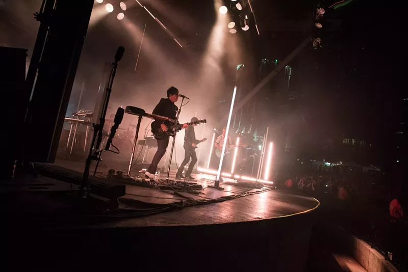 Image: Queens of the Stone Age performing on stage at FPL Solar Amphitheater