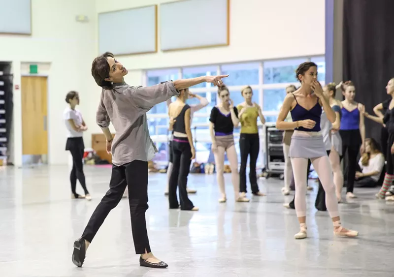 Image: a ballet teacher poses in front of a class of students