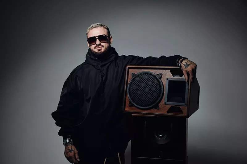 Image: Picture of a man holding an amplifier.