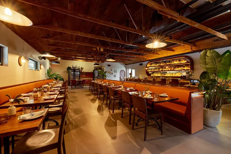 Image: a large dining room with wood chairs