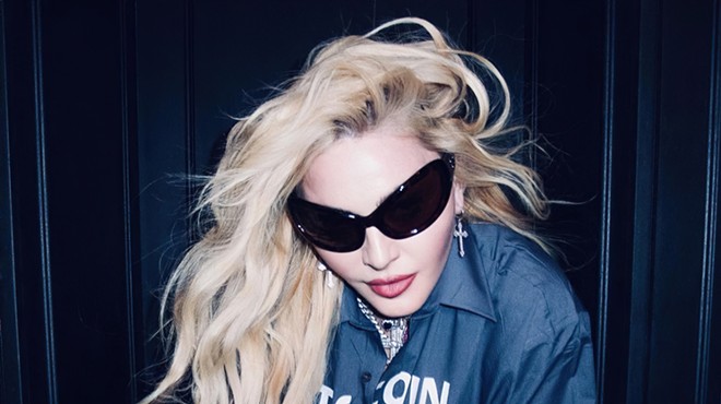 Portrait of Madonna with long blonde hair and sunglasses