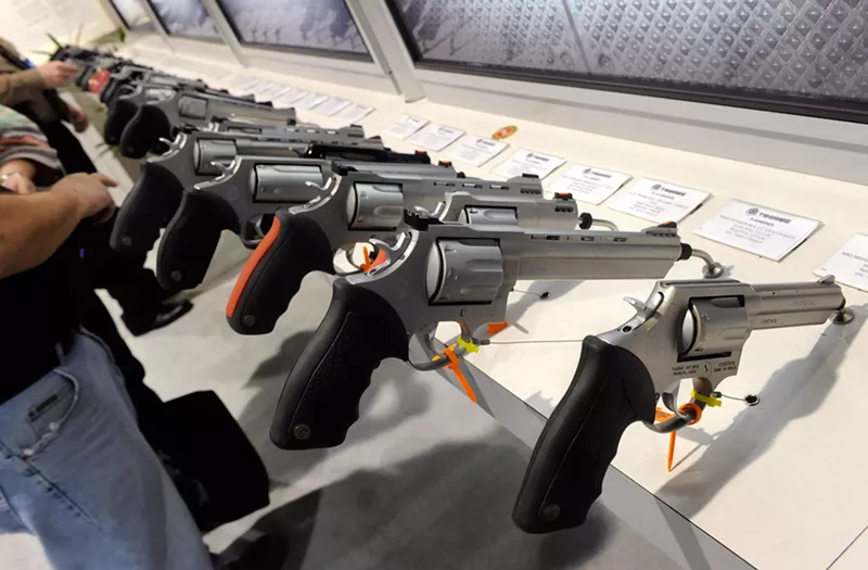Image: Handguns at the Taurus International Firearms booth at the National Shooting Sports Foundation's 33rd annual Shooting, Hunting and Outdoor Trade (SHOT) Show on January 18, 2011, in Las Vegas
