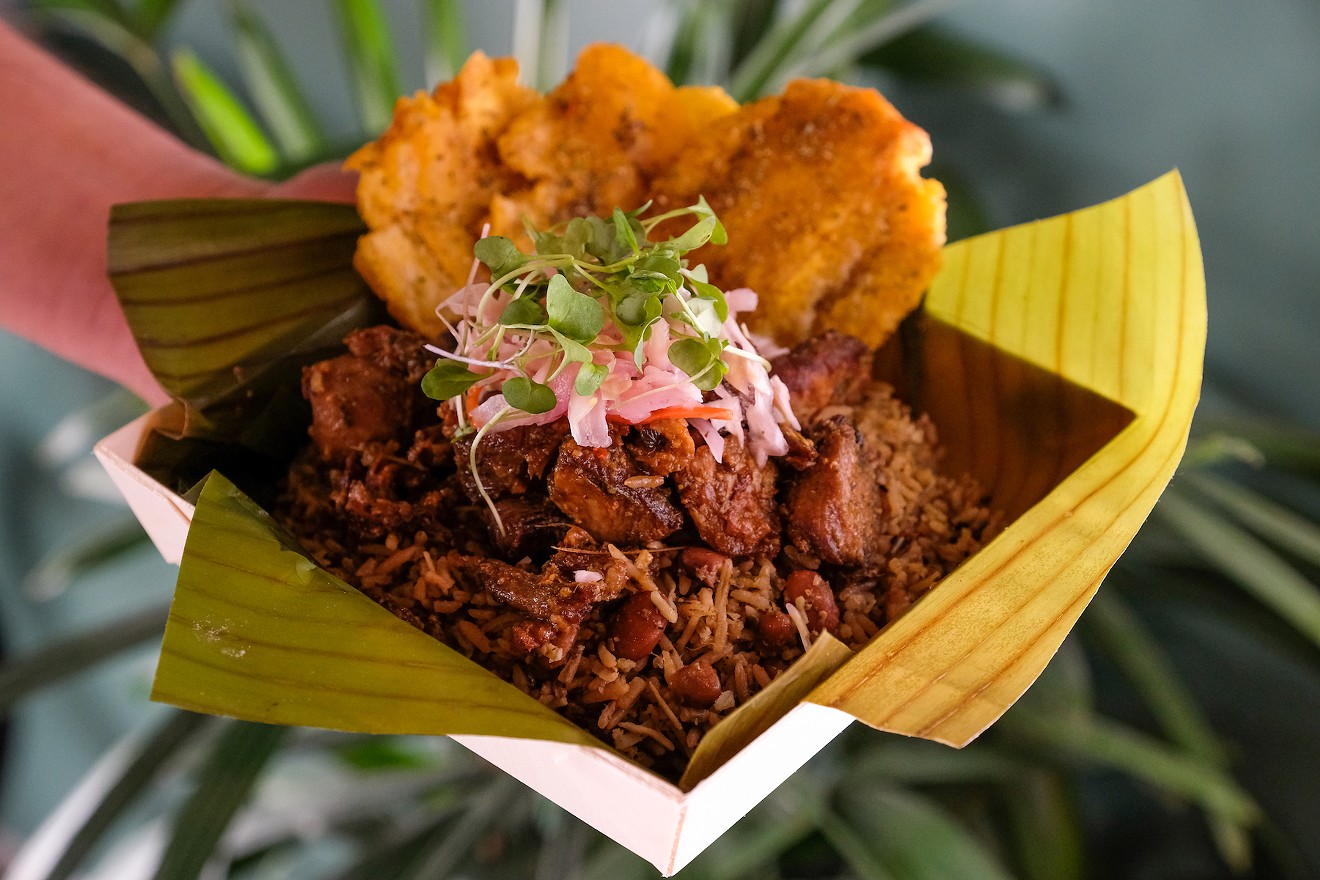 Manjay's griyo with bannann peze — braised and fried pork shoulder with fried plantains, served with traditional Haitian rice.