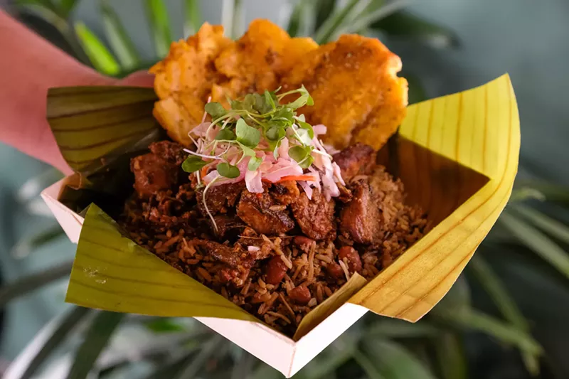 Image: Manjay's griyo with bannann peze — braised and fried pork shoulder with fried plantains, served with traditional Haitian rice.