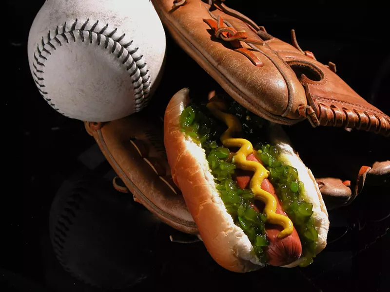 Image: A heavily garnished wiener tucked inside a baseball glove
