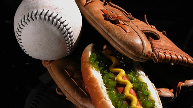 A heavily garnished wiener tucked inside a baseball glove