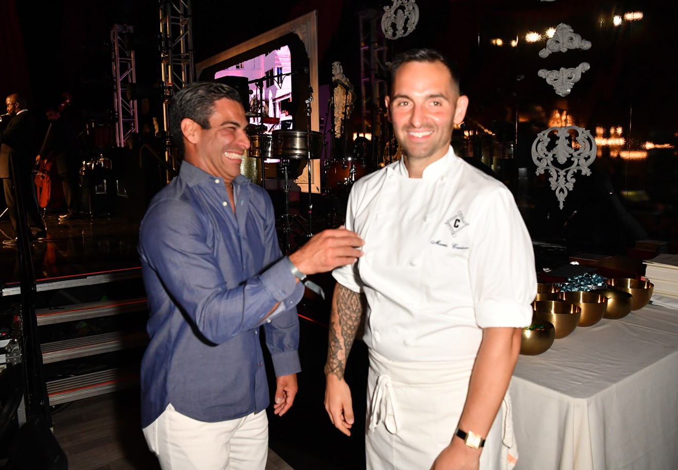 Mayor Francis Suarez kicks it with chef Mario Carbone at the American Express Presents Carbone Beach event on May 7, 2022, in Miami Beach. Suarez's attendance at a similar event the following year prompted an ethics complaint by activist Thomas Kennedy.