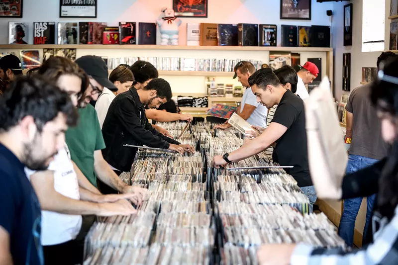 Image: People vinyl digging at a record store