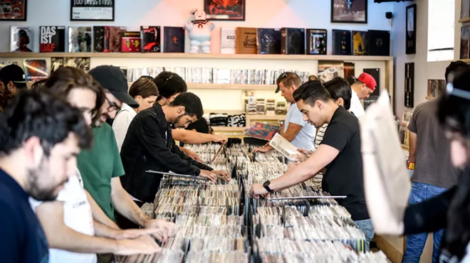 People vinyl digging at a record store