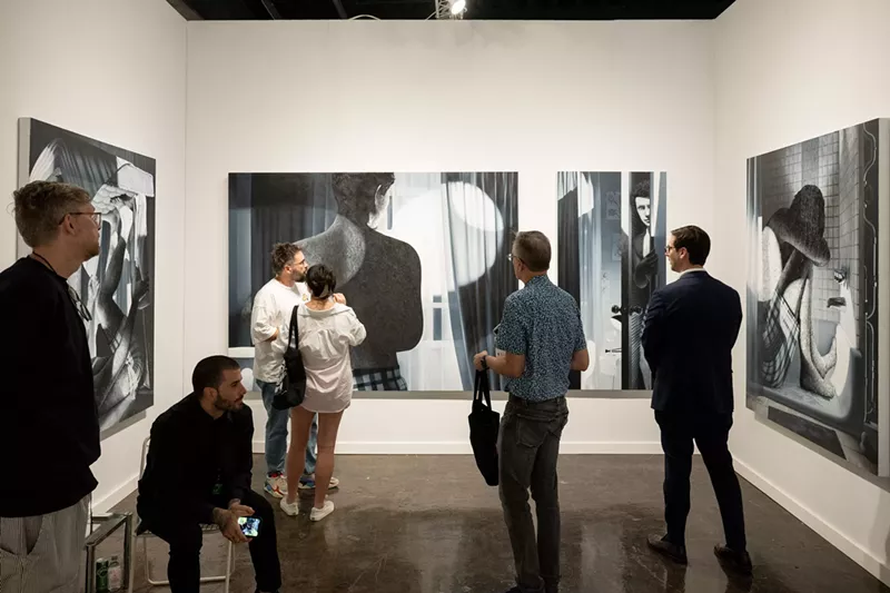 Image: People observing the booth of Primary gallery at NADA art fair in Miami