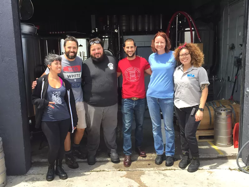 Image: Josh Hubner (in the red shirt) and the brew crews from Lincoln's Beard Brewing and M.I.A. Beer Company.