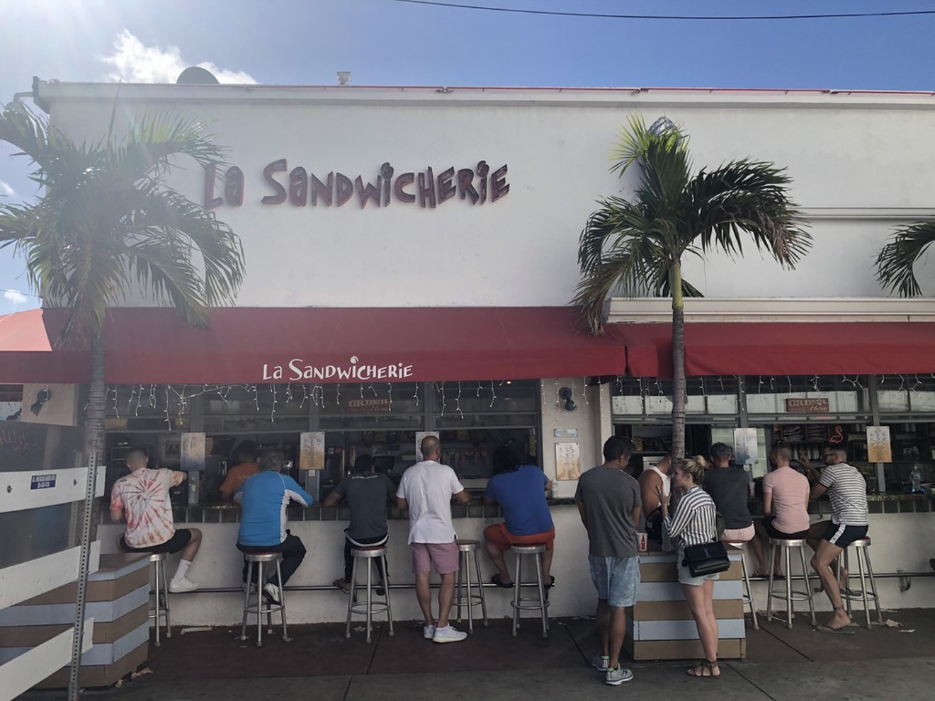 Customers sneak in a bite at La Sandwicherie amid the coronavirus crisis.