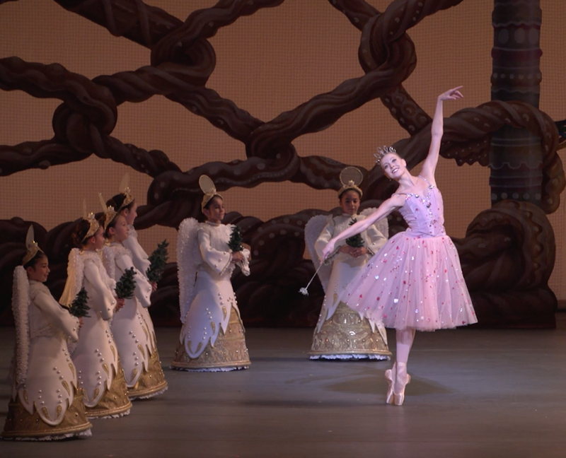 Image: Miami City Ballet principal dancer Dawn Atkins dancing in The Nutcracker, surrounded by young dancers dressed as angels