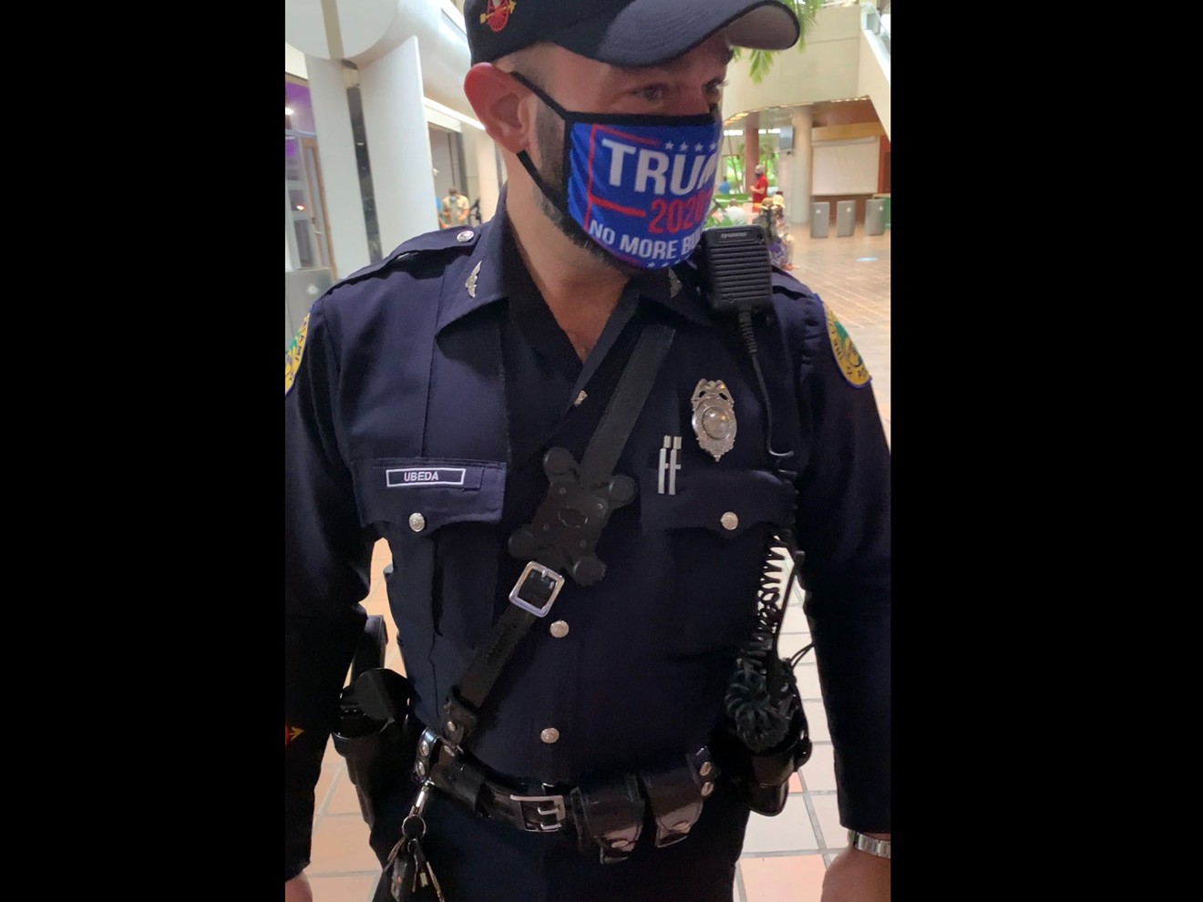 A Miami police officer was photographed in a polling place wearing a Trump 2020 mask.