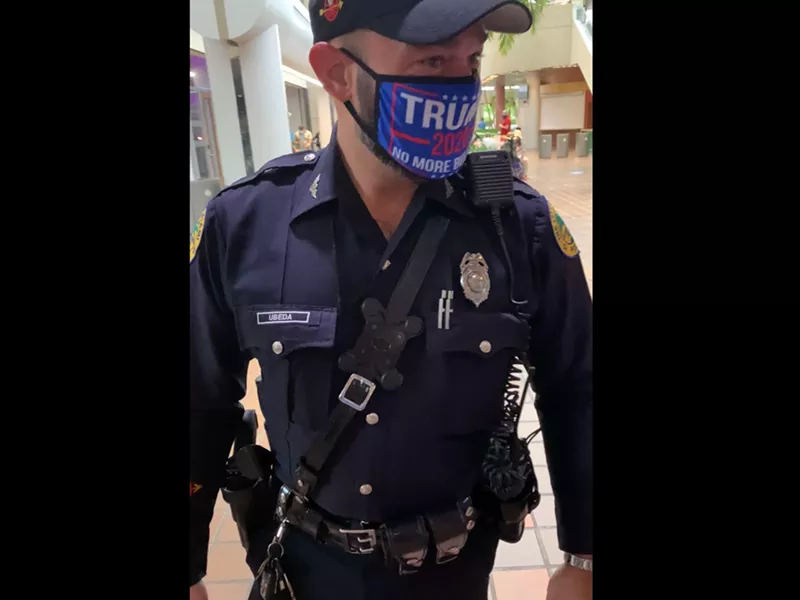 Image: A Miami police officer was photographed in a polling place wearing a Trump 2020 mask.