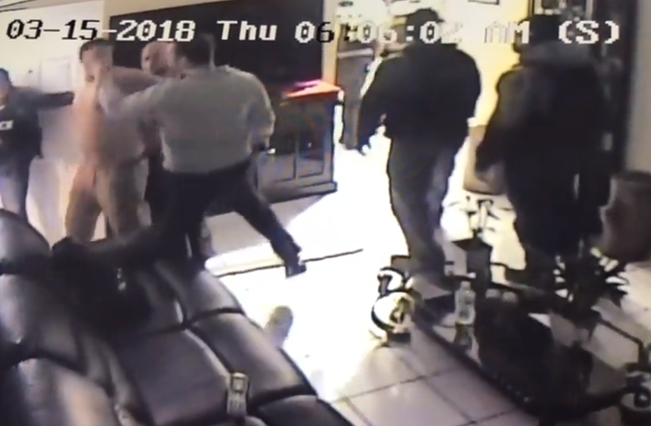 Miami-Dade Police Sgt. Manuel Regueiro is seen slapping a handcuffed suspect.
