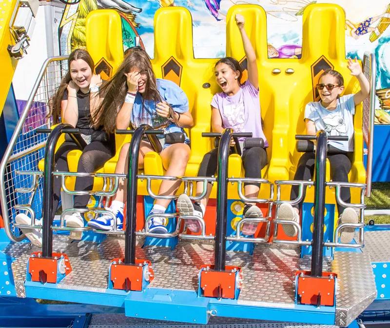 Image: Four young girls on a carnival ride