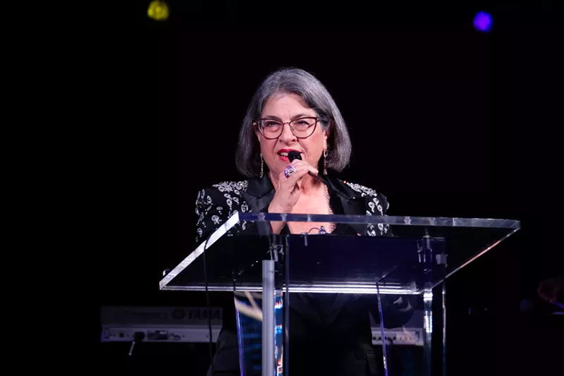 Image: Miami-Dade County Mayor Daniella Levine Cava speaking at a podium during the Miami-Dade Chamber of Commerce’s 19th Annual Holiday Gala