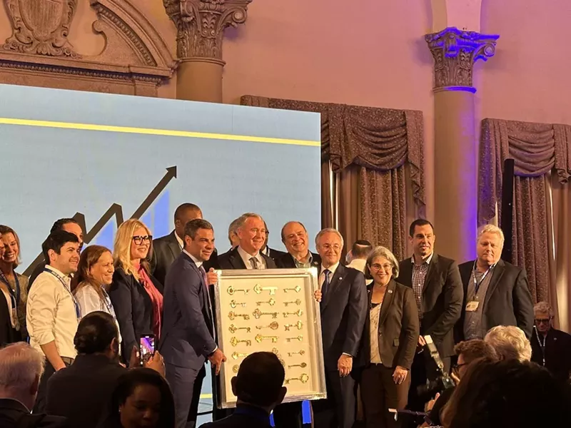 Image: Hedge fund billionaire Ken Griffin standing alongside local leaders while being presented with honorary keys to nearly two dozen Miami-Dade cities.