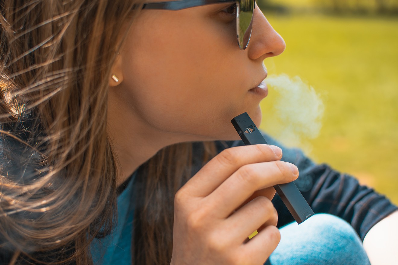 A young woman with a Juul.