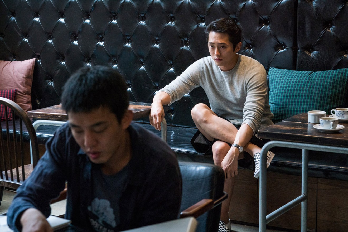 Ah-In Yoo (left) and Steven Yeun in Burning.