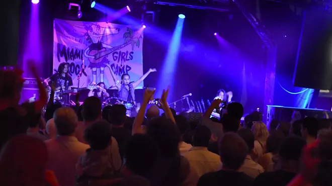 A young band performing in front of a crowd.