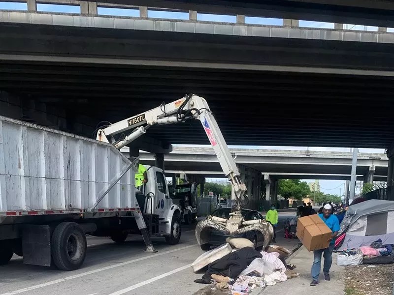 Image: City of Miami workers at the site of a homeless encampment in Overtown on the morning of May 13.
