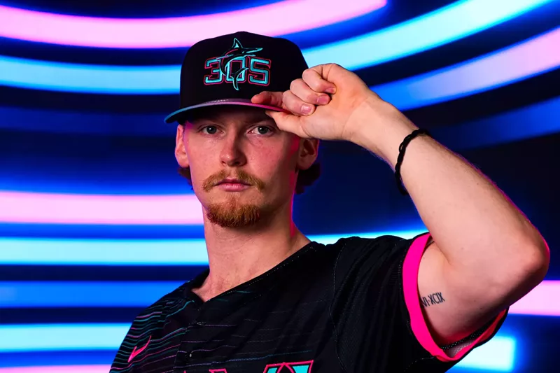 Image: baseball player modeling baseball cap reading "305"