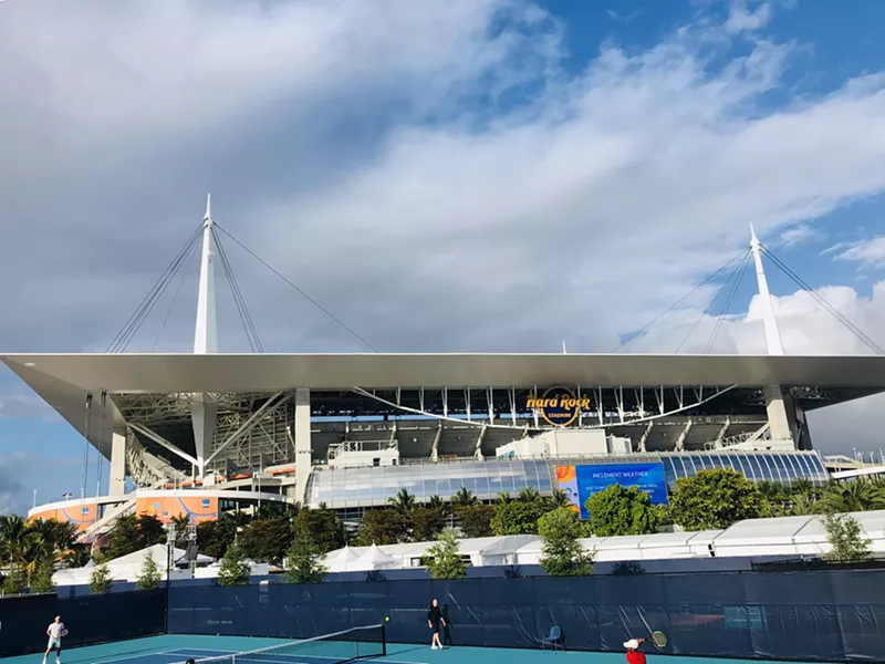 Image: Tennis legend Roger Federer warms up on a practice court before hitting the stadium for his match.