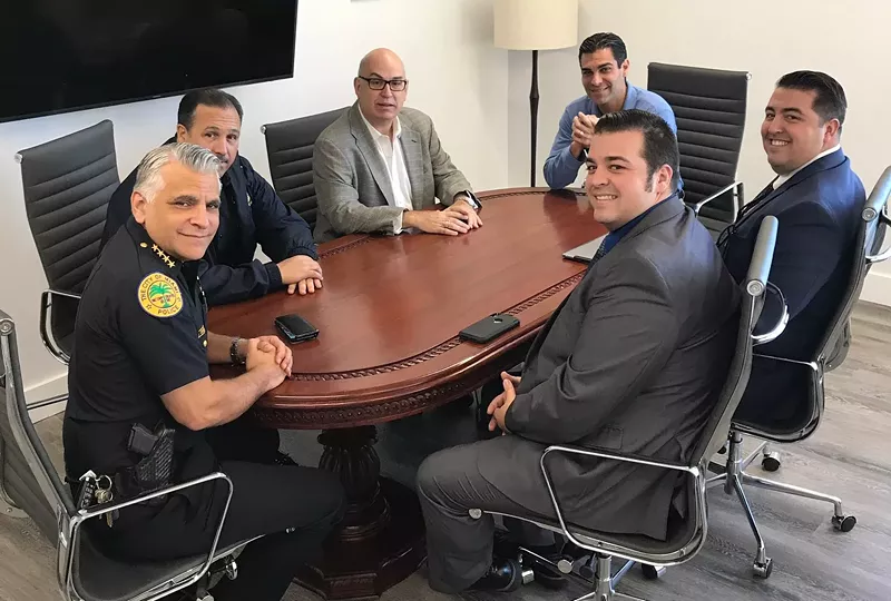 Image: Miami FOP Vice President Matt Reyes (navy suit, foreground) has pledged to "take the offensive" in conversations about police reform.