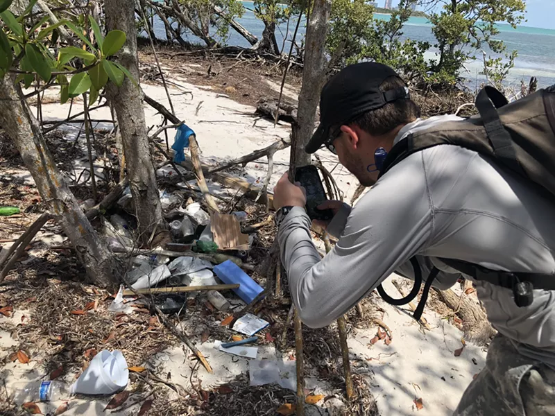 Image: Andrew Otazo photographs trash in Bear Cut Preserve.