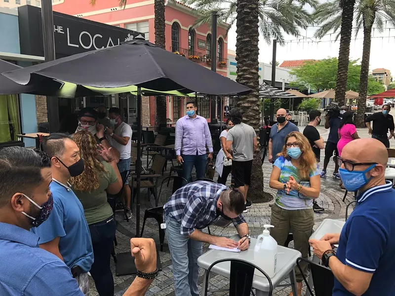 Image: Restaurant owners gather to organize this Friday's protest in downtown Miami.