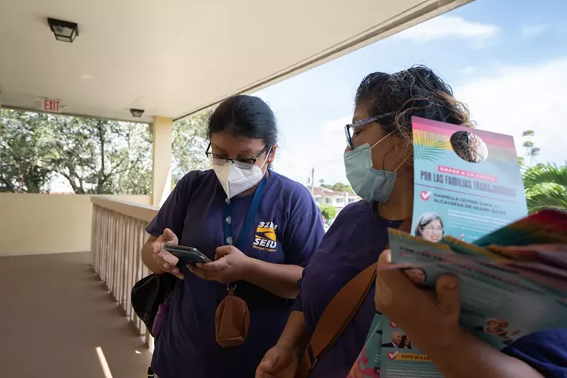 Image: Elizabeth Valderrama, left, and Alejandra Poccori, right, of 32BJ SEIU, canvass in Little Havana for Amendment 2.