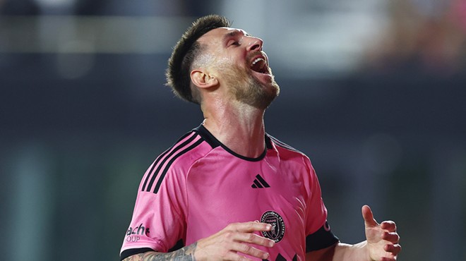 Photo of Inter Miami FC star Lionel Messi, clad in pink and looking ecstatically skyward