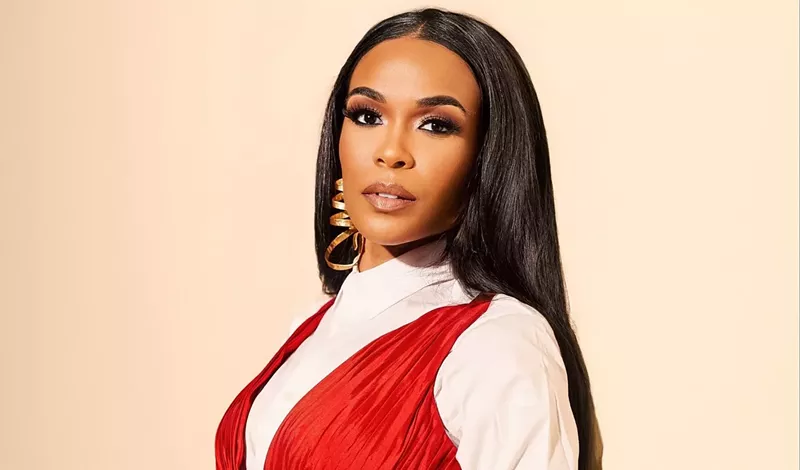 Image: headshot of singer Michelle Williams in a red and white outfit