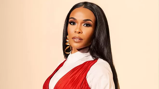 headshot of singer Michelle Williams in a red and white outfit