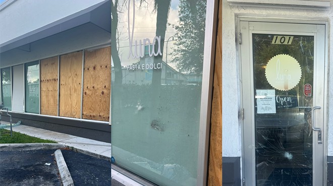 a restaurant with damage to glass storefront