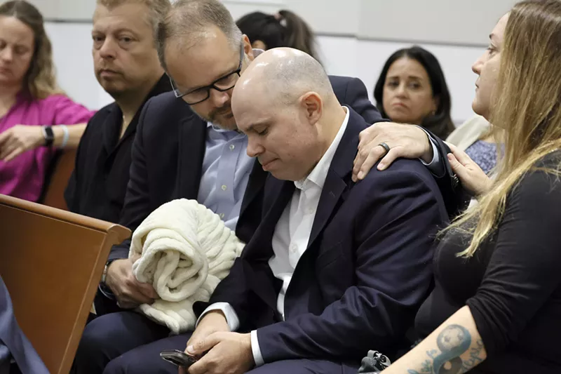 Image: Ryan Petty comforts Ilan Alhadeff as they await the verdict in the sentencing trial of Nikolas Cruz at the Broward County Courthouse in Fort Lauderdale on October 13, 2022. Petty's daughter, Alaina, and Alhadeff's daughter, Alyssa, were killed in the 2018 shooting at Marjory Stoneman Douglas High School.