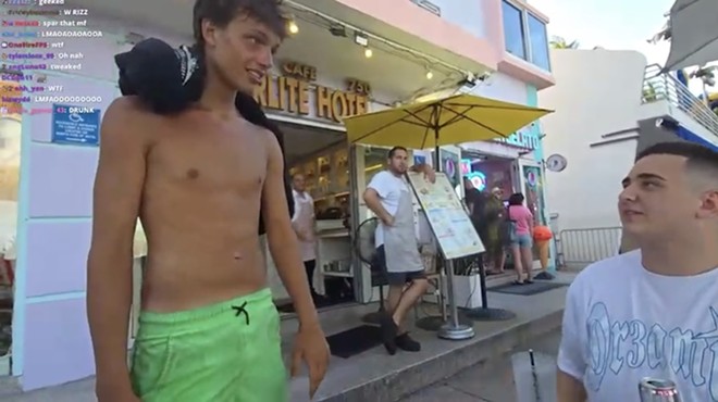 17-year-old Troy Coleman, shirtless, wearing bright green shorts