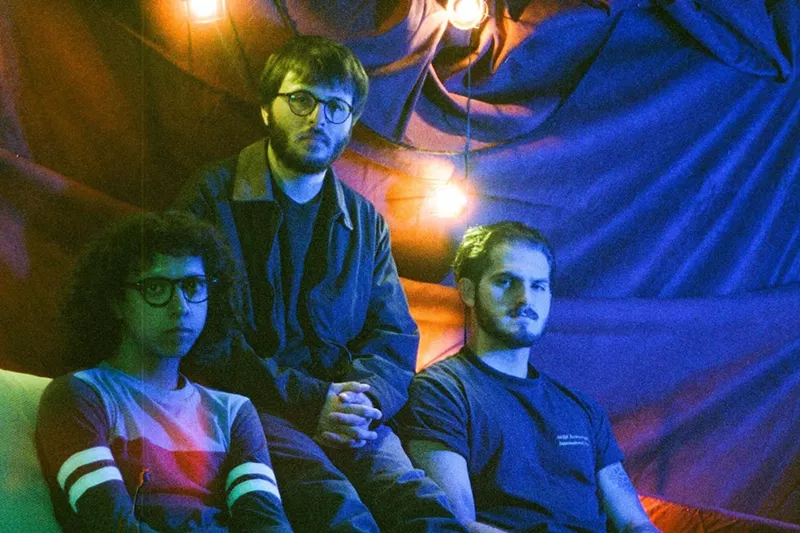 Image: Carlo Barbacci (middle) sits with Mold bandmates.