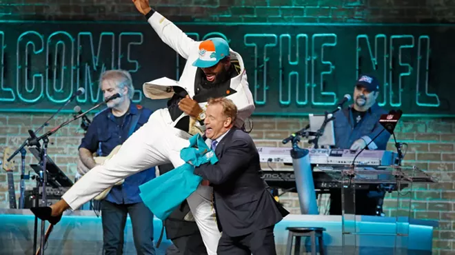 Christian Wilkins jumps next to NFL Commissioner Roger Goodell after he is drafted by the Miami Dolphins during the 2019 NFL Draft in Nashville.