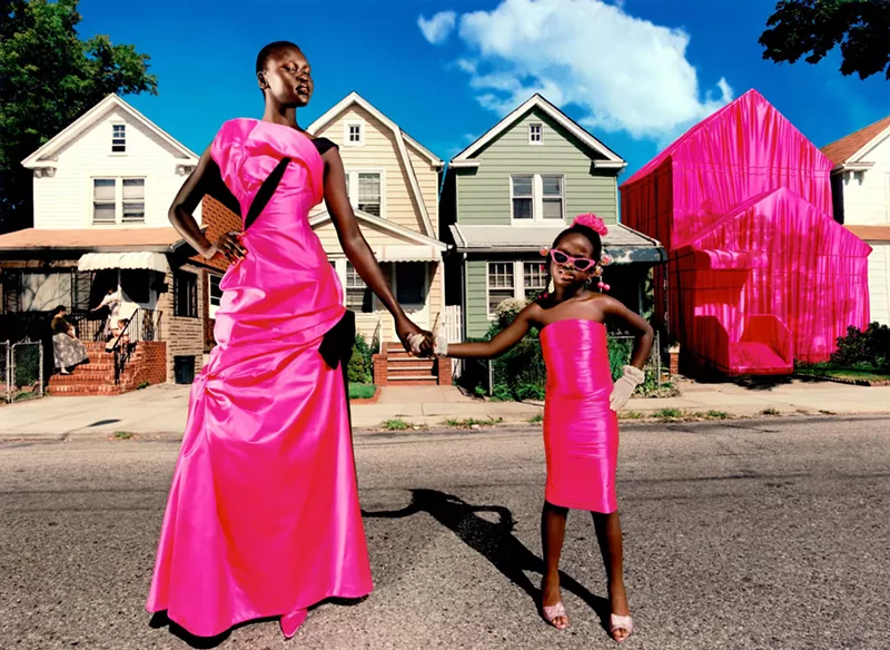 Image: Photo by David LaChapelle featuring a young black woman and child dressed in hot pink