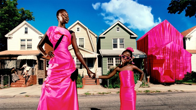 Photo by David LaChapelle featuring a young black woman and child dressed in hot pink
