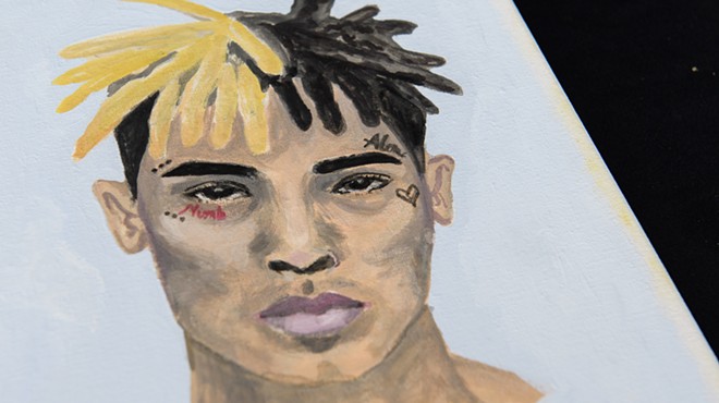 A portrait painted by a fan and left at a makeshift memorial outside the XXXTentacion Funeral & Fan Memorial at BB&T Center in Sunrise, Florida, on June 27, 2018