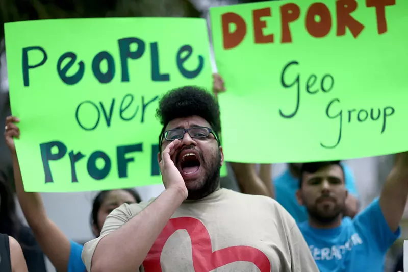 Image: Activists protesting in front of GEO Group's headquarters in Boca Raton.