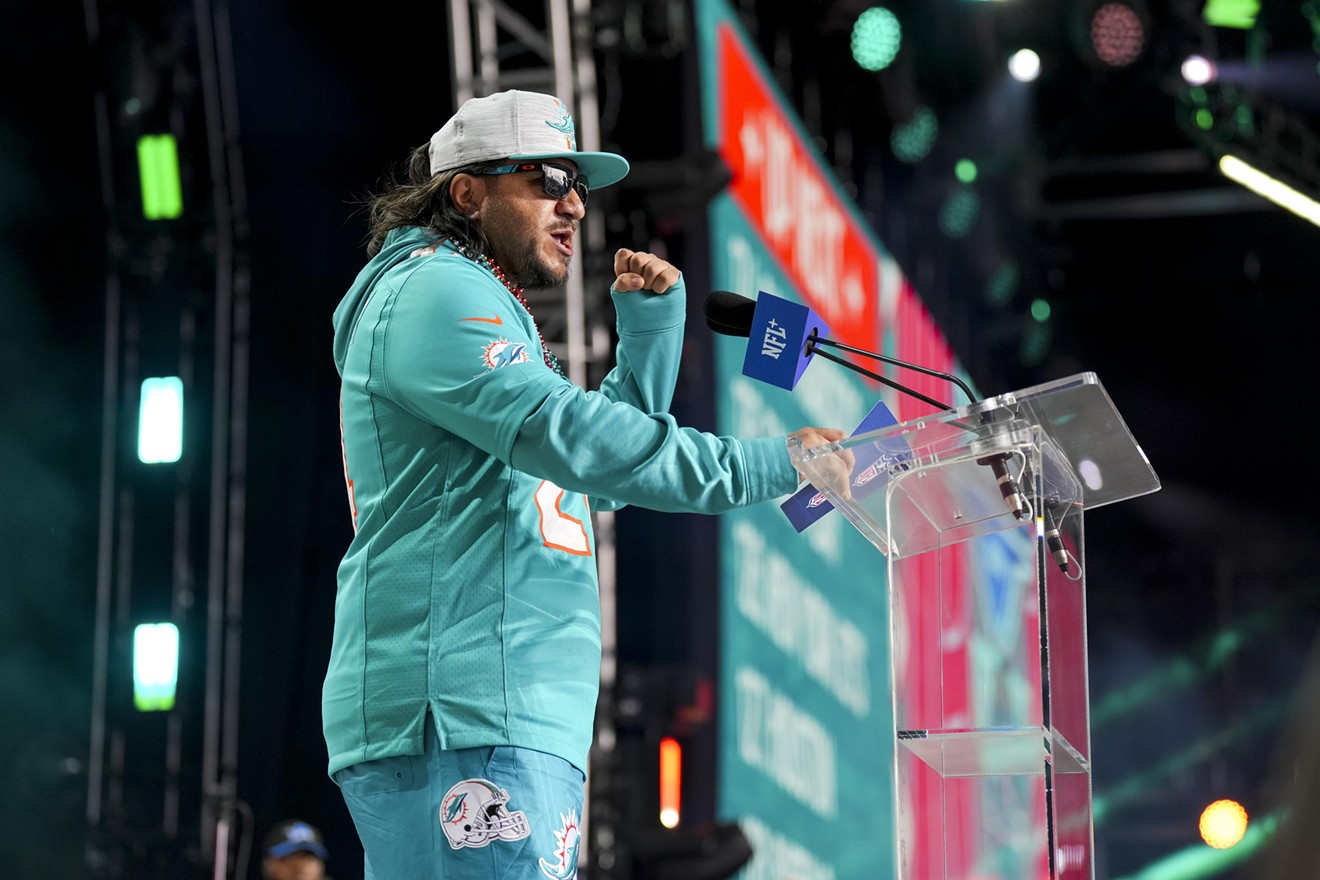 Armando Basurto raises his fist after naming a pick by the Miami Dolphins during round four of the 2024 NFL draft at Campus Martius Park and Hart Plaza on April 27, 2024 in Detroit, Michigan.