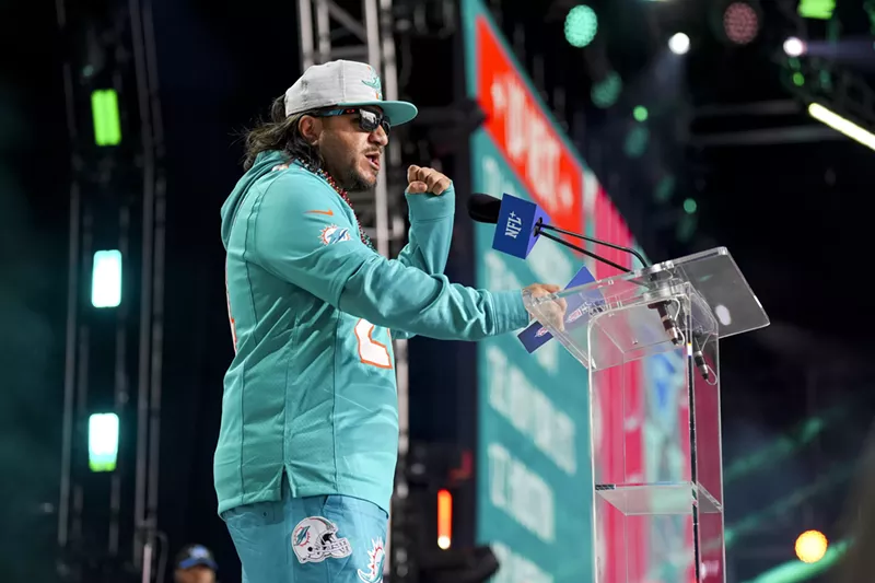 Image: Miami Dolphins announce an NFL draft pick at the podium at Campus Martius Park and Hart Plazza
