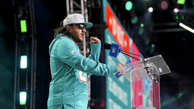 Miami Dolphins announce an NFL draft pick at the podium at Campus Martius Park and Hart Plazza